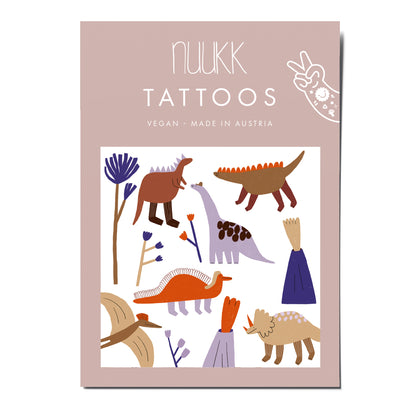 Tattoos von Nuukk mit Dinos und Vulkanen.